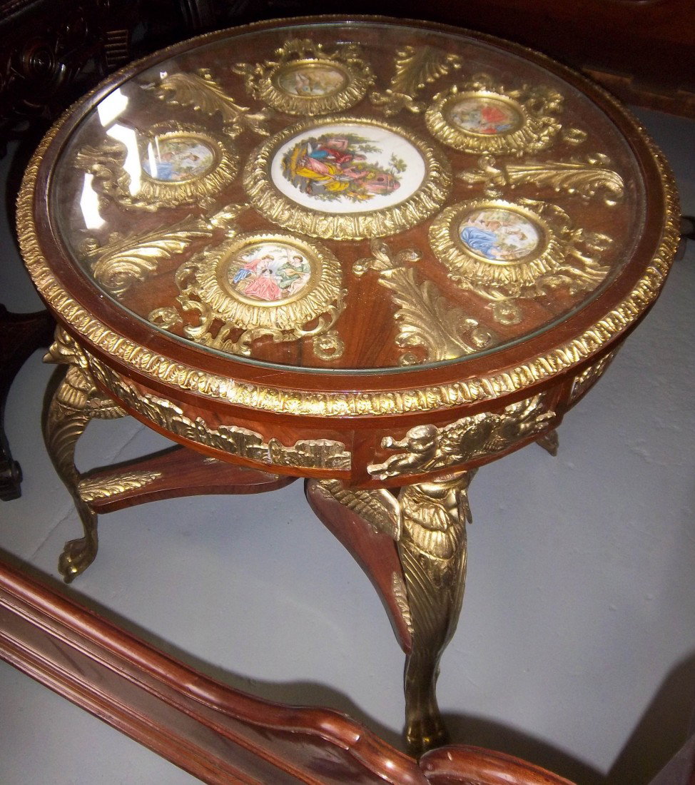 Bronze mtd. center table w/Sevres style plaque: Mahogany bronze mounted center table with Sevres stlye decorated plaques 25"hx26 1/2"diam. Auction Estimate $400-600