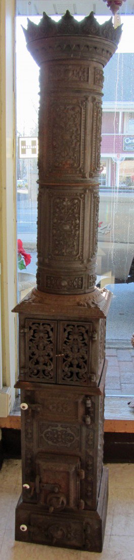Ca 1900 American cast iron chimney stove: Ca 1900 American cast iron chimney stove with cherubs and fancy iron work 76"h Auction Estimate 500-1500