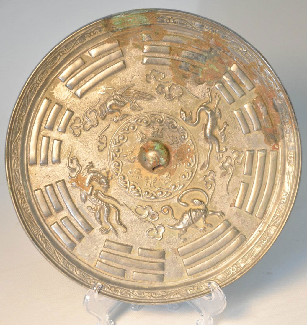 Antique metal mirror: Antique metal mirror, carved four Chinese traditional animal and the eight Diagrams on surface Auction Estimate 100-200