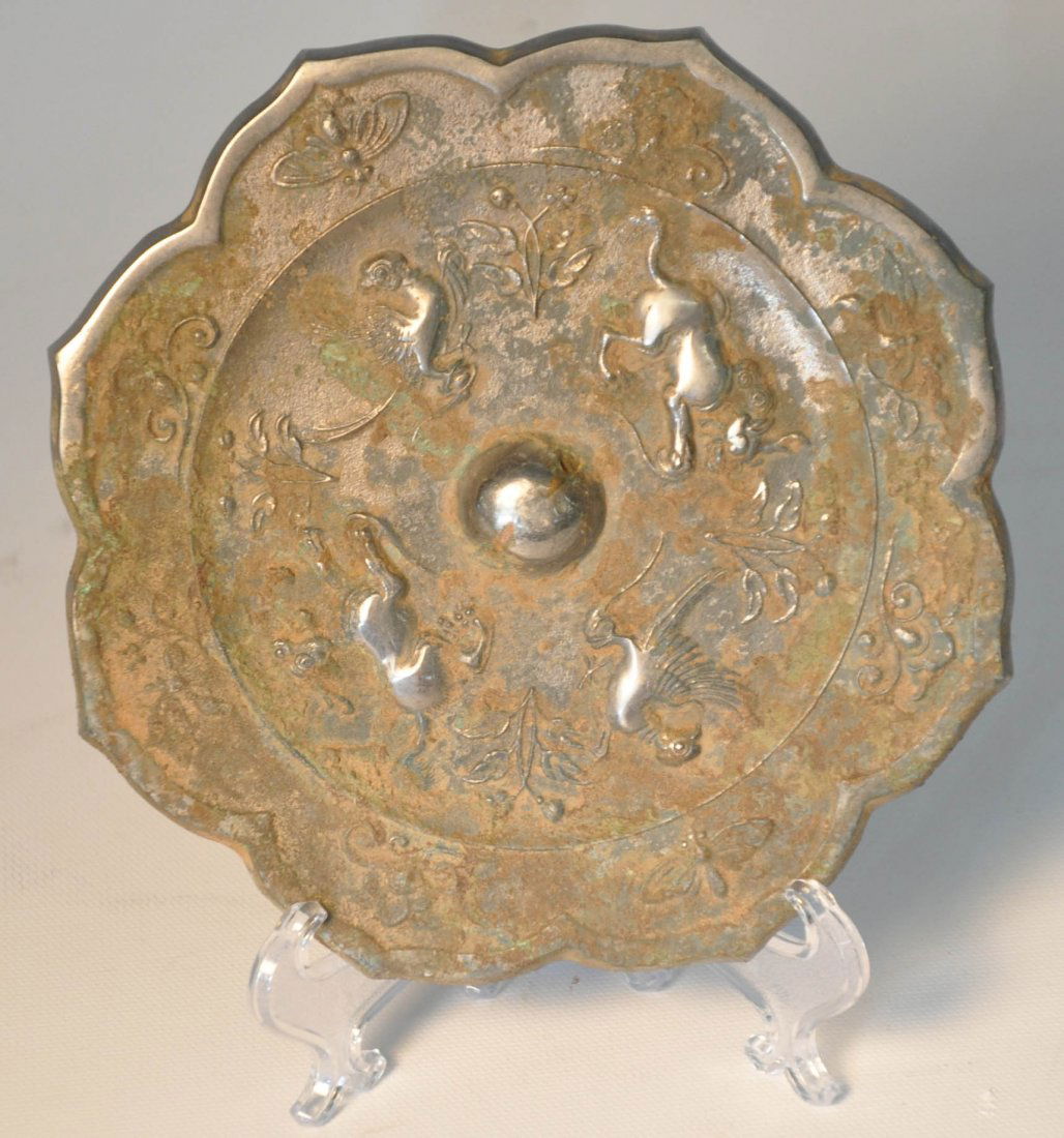 Antique metal mirror: Antique metal mirror flower shaped, carved four Chinese traditional animal on surface Auction Estimate 100-200