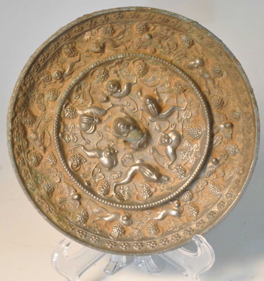 Antique metal mirror: Antique metal mirror, carved Chinese traditional animal and with grape design on surface Auction Estimate 100-200