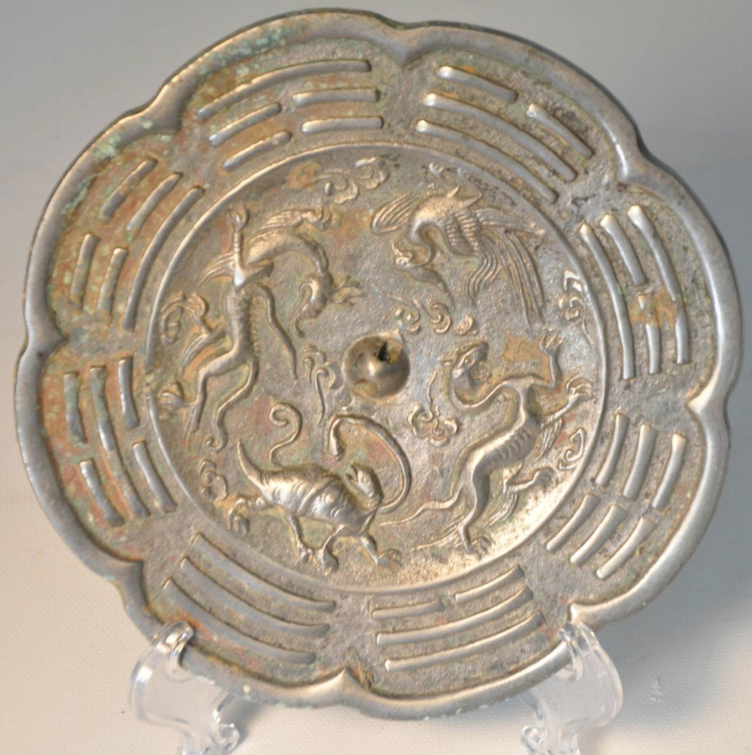 Antique metal mirror: Antique metal mirror, flower shaped, carved Chinese traditional animals and eight diagrams on surface Auction Estimate 100-200