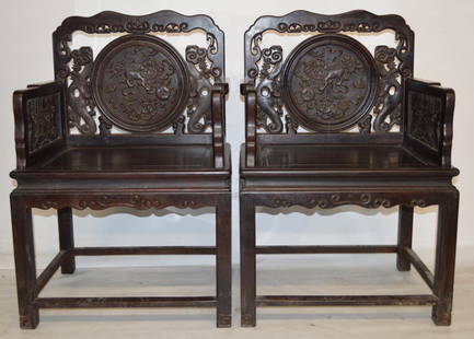 Pr. of Zitan carved wood chairs: Pr. of Zitan carved wood chairs, backs with detailed foo-lions and arms carved with flowers and bats 2000-4000