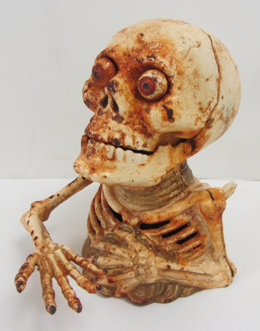 Cast iron skeleton bank: Cast iron skeleton bank 6 1/2 x 6 Auction Estimate 100-300