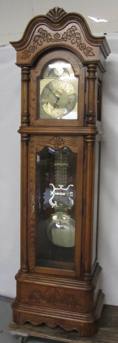 Quartersawn oak Howard Miller Grandfather clock: Mid 20th C. Quartersawn oak Howard Miller Grandfather clock 85"h Auction Estimate 400-800