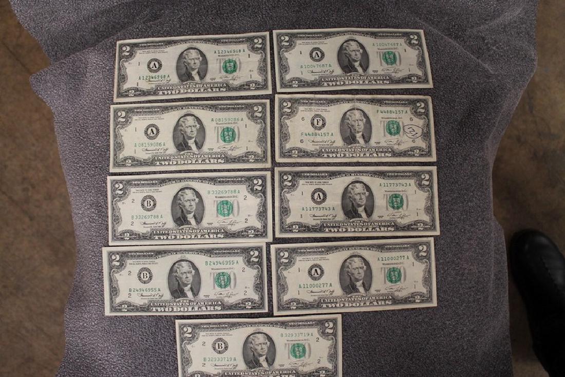 Lot of nine 1976 two dollar bills: Most are fine to very fine. One has been written on.
