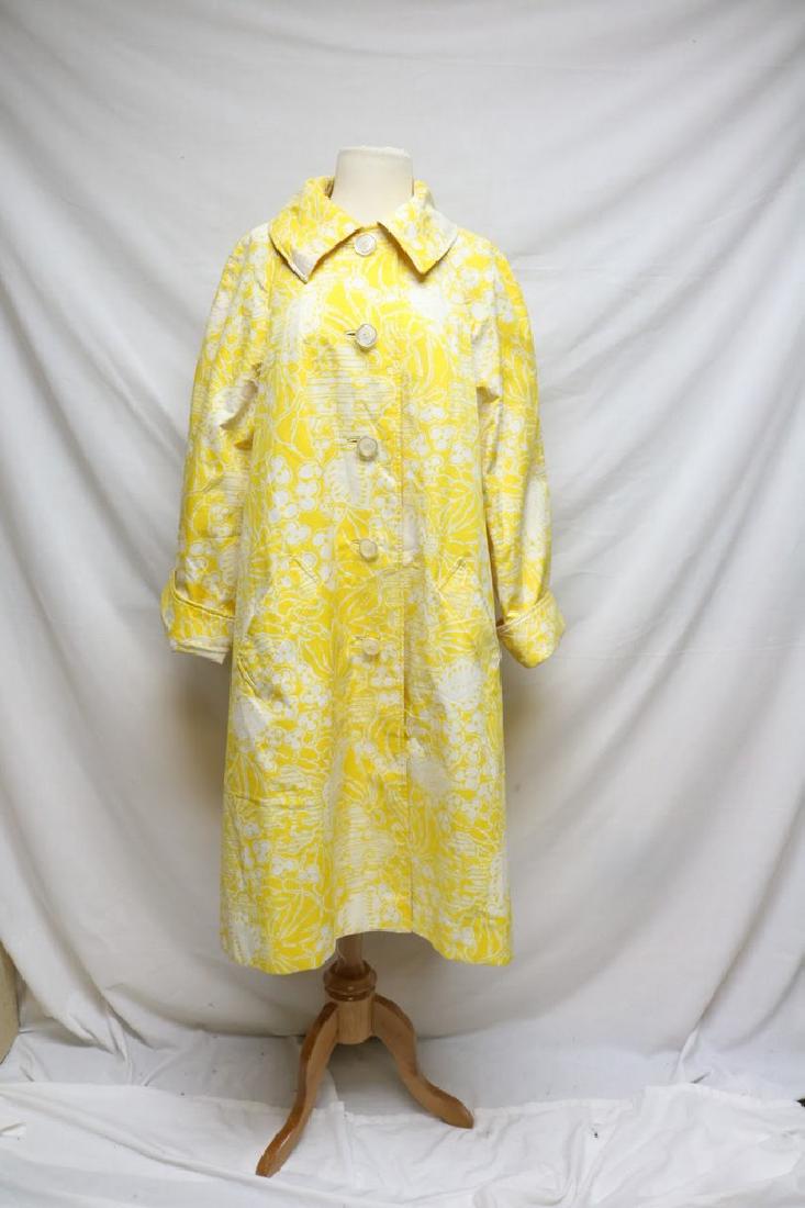 1960s floral raincoat: yellow/white floral print, long cuffed sleeves, small collar, buttoned front, fully lined (minor spots on the back of the left shoulder 45"/50"/56"/