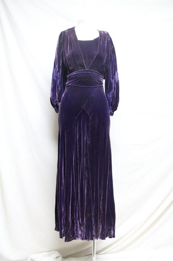 1930s Purple Velvet Gown: purple rayon velvet fabric, balloon sleeves with metal lame details, attached peplum, side snaps. Fair condition - foxing & fading throughout the dress. No rips/holes. 42 bust/ 38 waist (ties smaller)