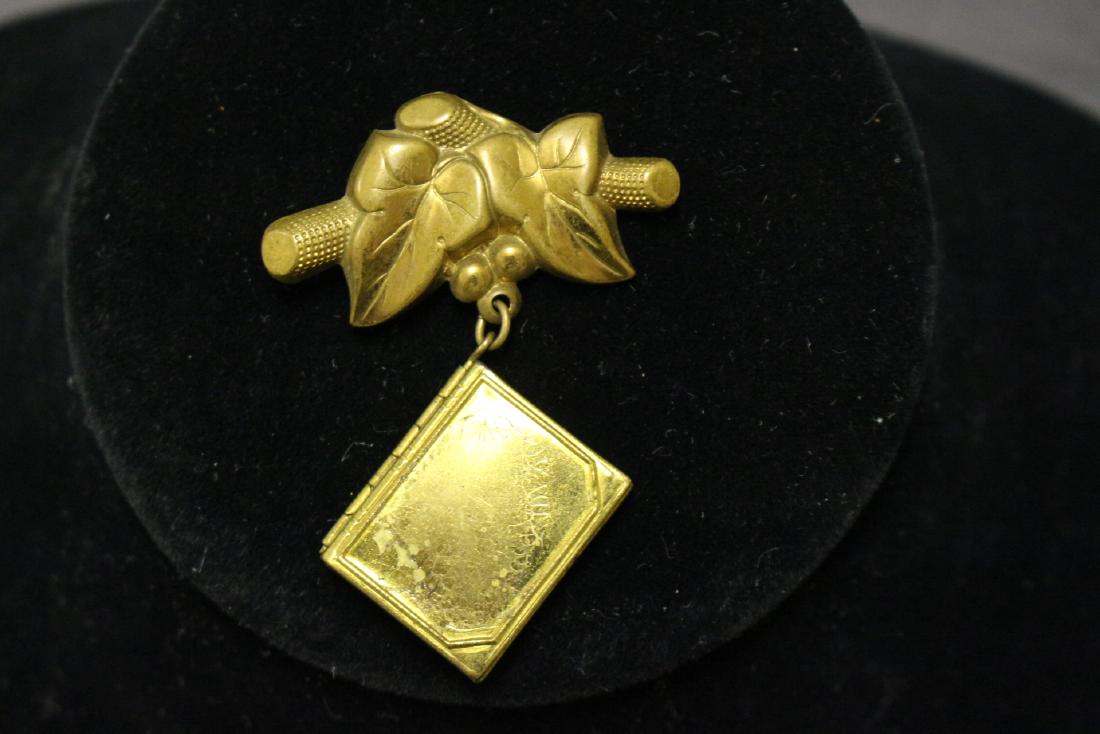 Vintage Brass Locket Brooch: brass metal - original sweetheart photos included. 2.5" x 1.5"