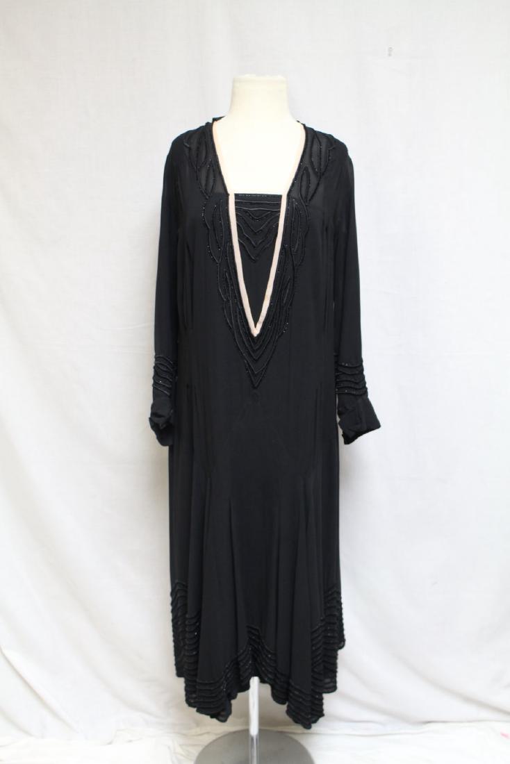Early 1920s Chiffon Dress: Silk and beaded trim detail. Good condition, a few loose seams, small holes at left waist. Has attached slip. 36"bust/46" length.