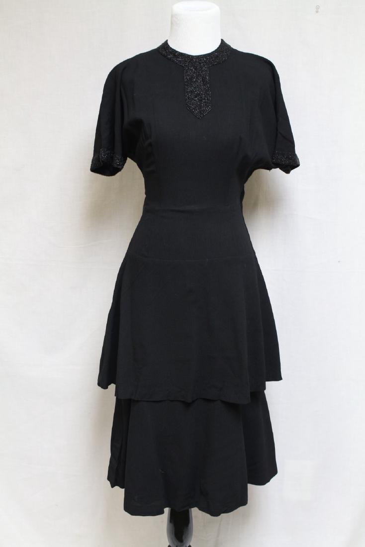 1940s Beaded Dress: Wool Crepe fabric, heavily beaded neckline and sleeves. 36" bust/27" waist. One small hole near hem- see photo, some pulled darts on bodice.