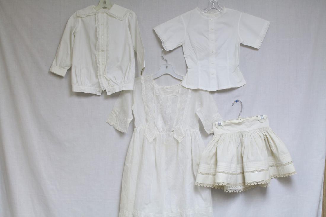Antique Lot of 4 Girls Clothing: 1 - lace trim skirt, good condition - minor foxing. 1 - white cotton dress, good condition. 1 - long sleeve cotton blouse, great condition - a few pin dot spots. 1 - short sleeve cotton blouse - excel