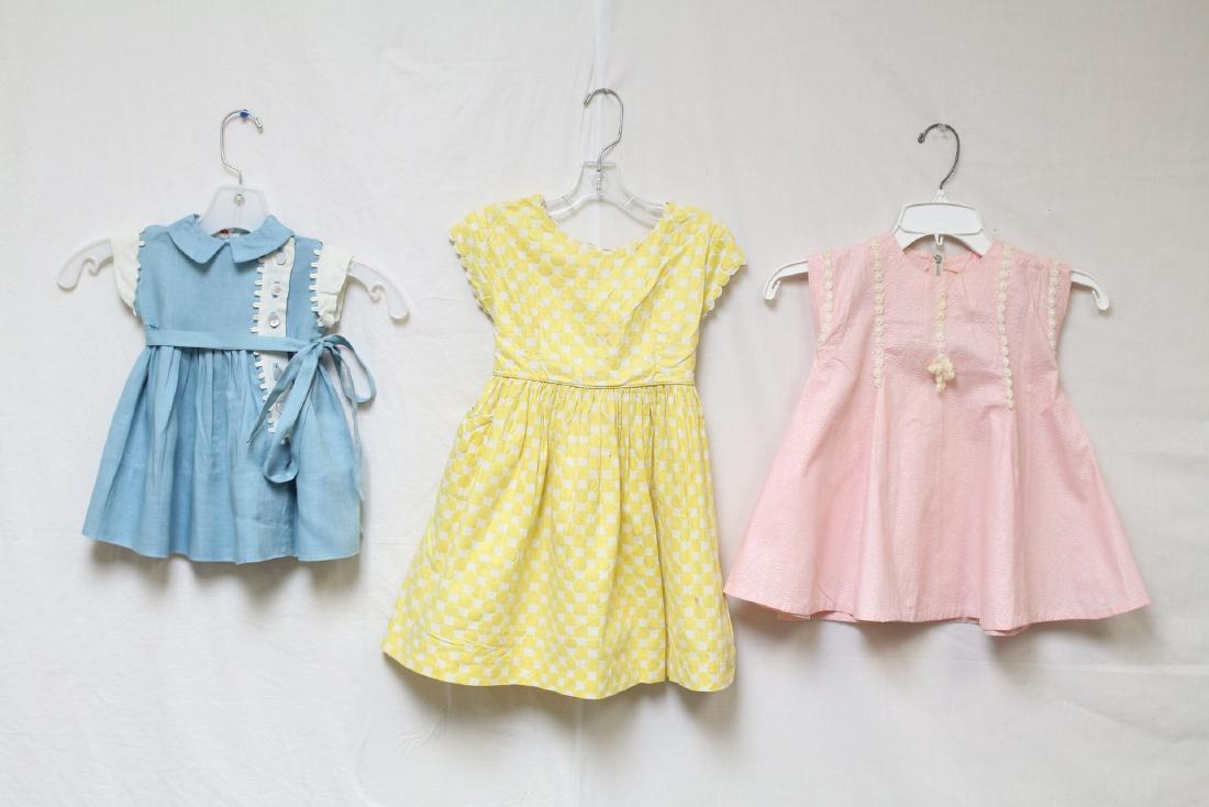 Vintage 1950s Lot of Girls Pastel Dresses: 1 - blue Frances Eiseman rayon linen has a small open seam, 22 chest/16 length, marked size 1. 1 - yellow polka dot seersucker cotton, good condition with two tiny light spots and one missing back but