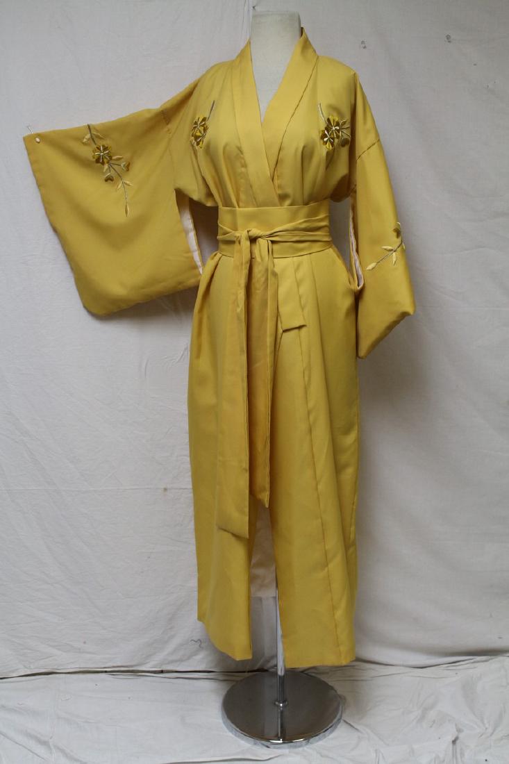 Vintage Japanese Kimono: Yellow kimono, Made in Japan, 100% Polyester. Hand silk embroidered flower details. Full length. Waist and bust measure approx 48 inches. Small stain at bottom front (see photo) but otherwise in good