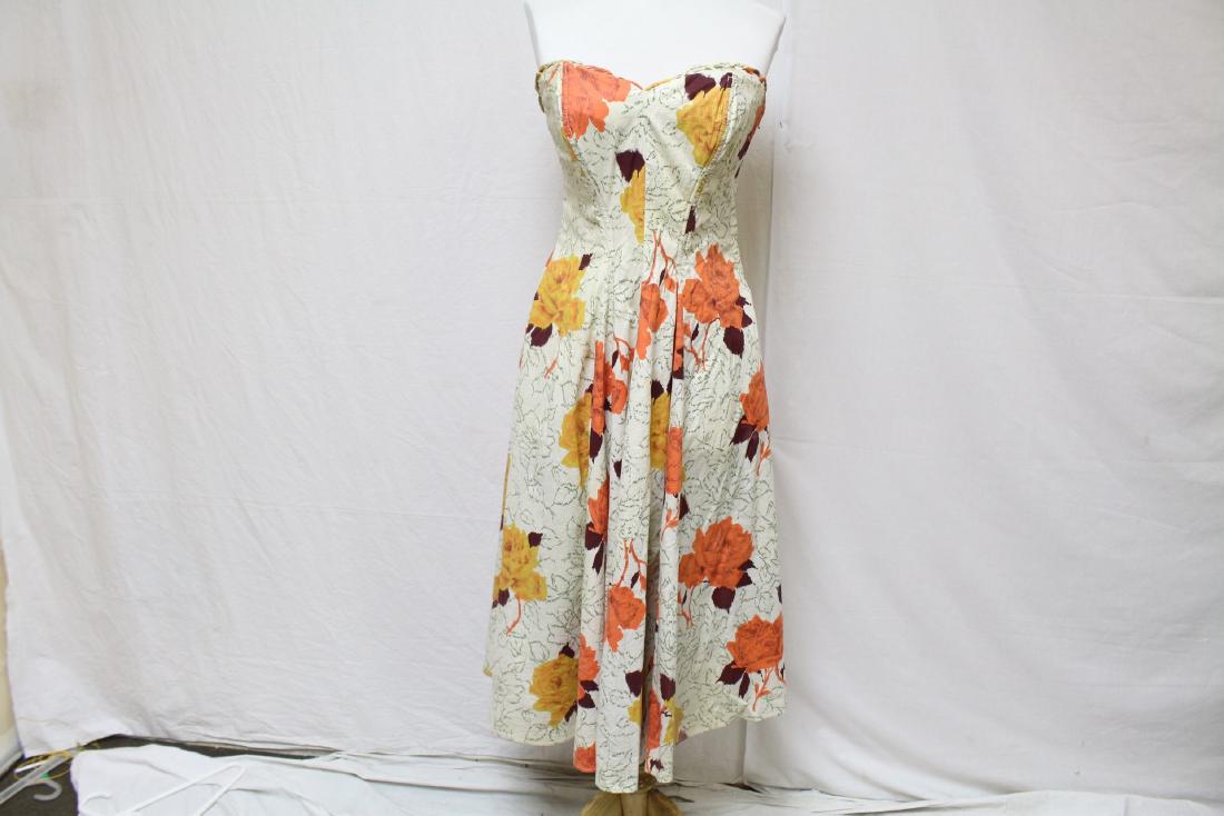 Vintage Floral Strapless Dress: fit and flare, boning and loop trim at bustline, cotton floral cream backgroune with orange yellow and green, metal side zipper, see photos for spots, approx bust 30" waist 28"
