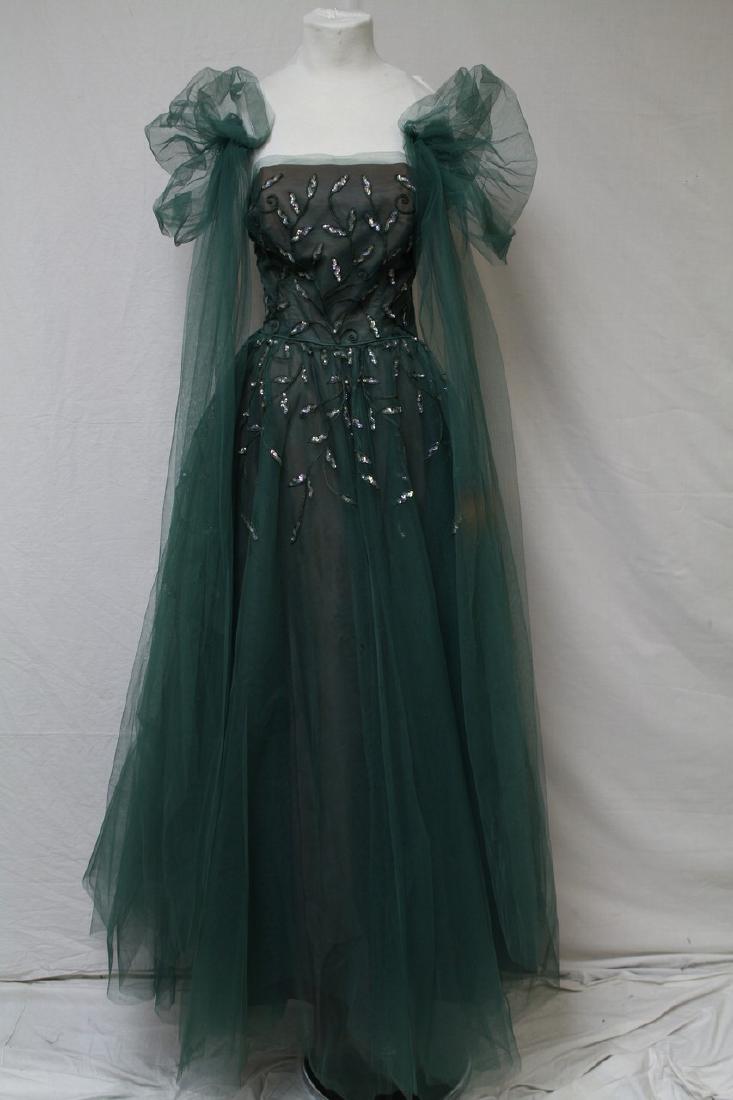 Vintage Emerald Green sequined Tulle 1950's Gown: strapless, no tags, side metal zipper, double lined, lining is brown, tulle emerald green also has tulle sleeves/wrap, has sequined leaf design, boning is loose, small hole in tulle some discoloration