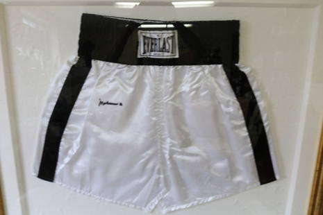 Muhammad Ali, signed Boxing Trunks: framed black & white satin trunks, approx. 33 1/2 x 39 1/2 inches