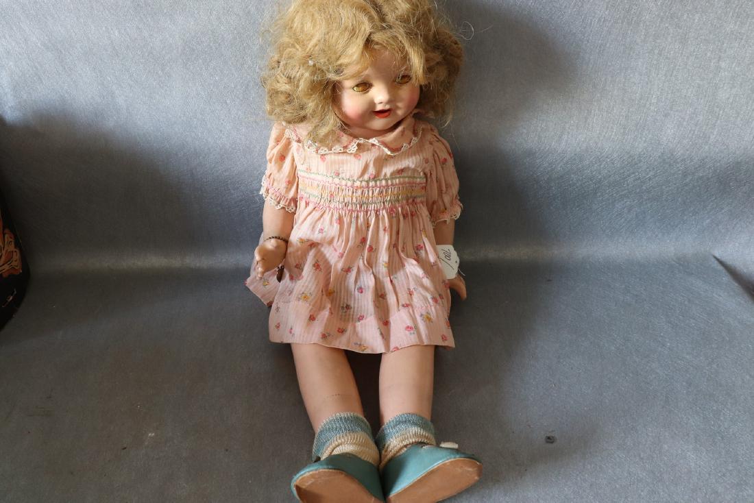 Vintage Effanbee Patsy Lou Doll: with pink floral dress socks and blue shoes, open mouth with teeth, eyes are discolored, hair needs cleaning and combing, approx. 21 inches tall