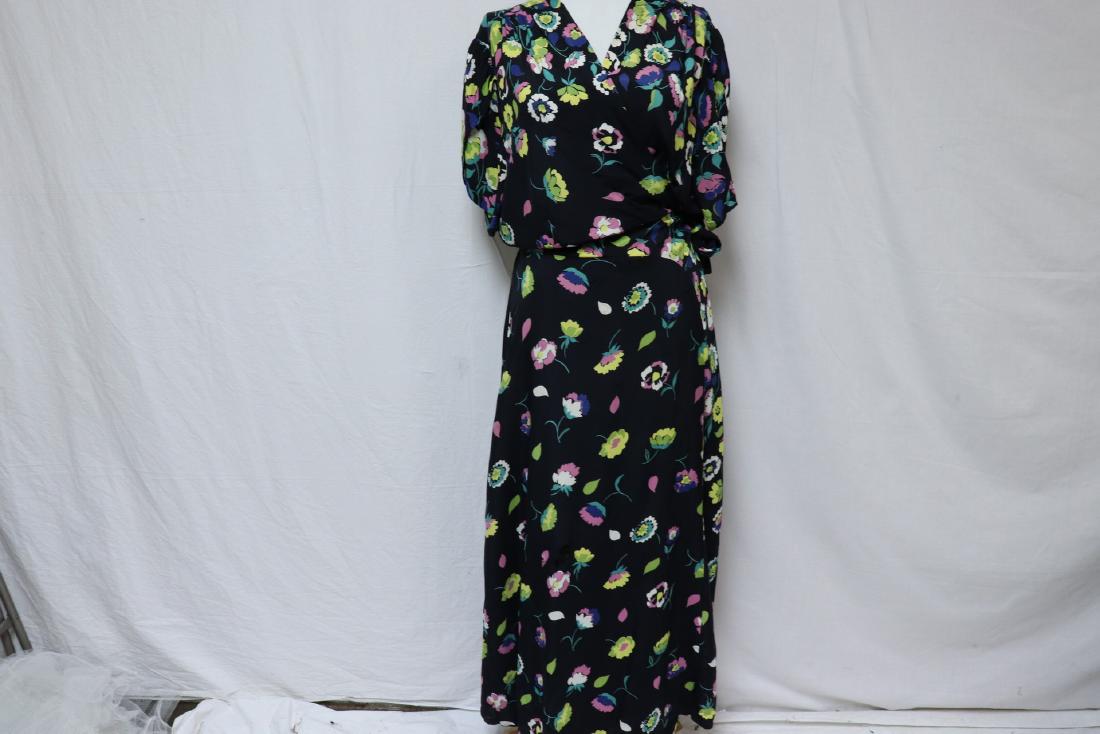 1940's Floral Wrap: Black background with bright floral design, rayon day dress. Tulip sleeves, about 40" across bust. In good condition with a few small scattered holes.