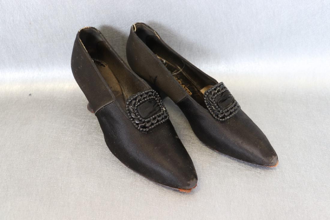 Pair Vintage 1890's J & J Slater Black Satin Women's: Black satin body, leather sole, decorative metal clip detail. Measures about 9" long. Some wear on toes, some wear on satin body and a 1" rip on the right shoe. Marker J&J Slater, New York.
