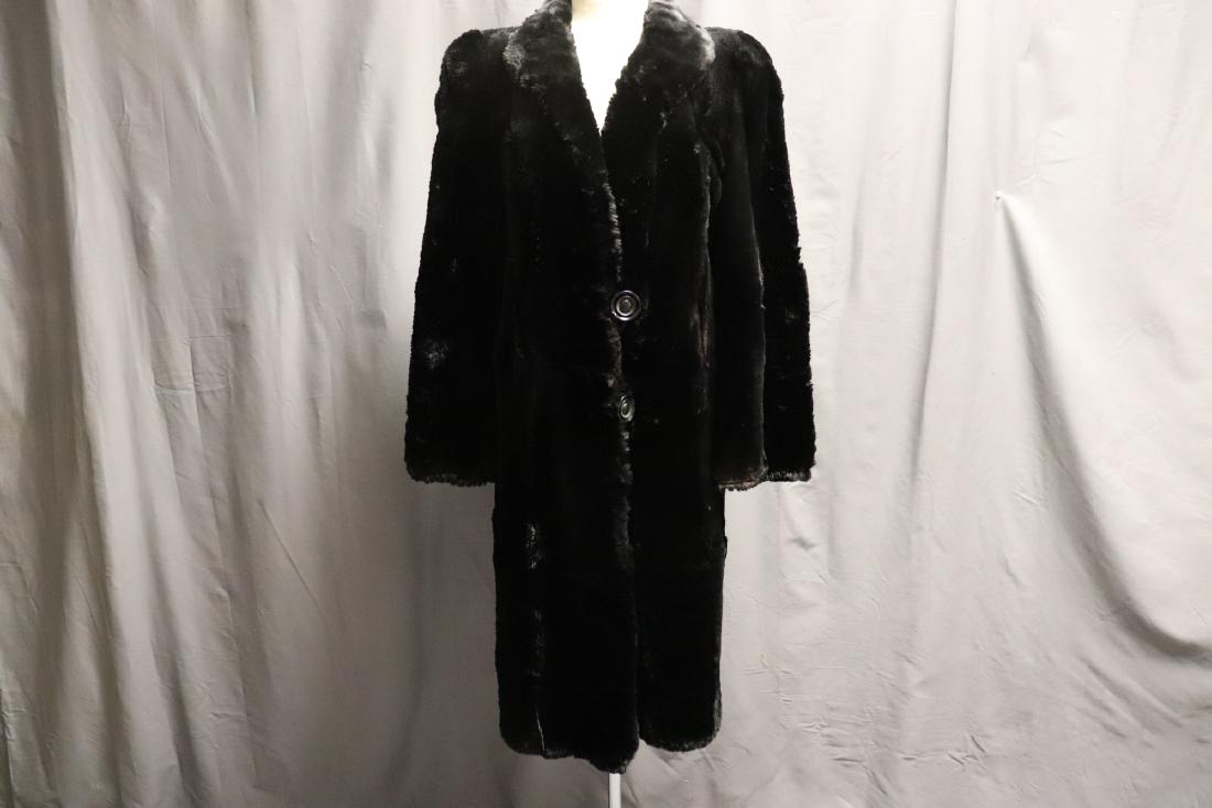 1940's House Of Castor Ladies Fur Coat: Not a Fur expert but possible Black Seal Fur, Nice Coat, large black buttons, shawl collar, beautiful lining, some wear on right elbow area, otherwise in nice condition, approx. 42 bust