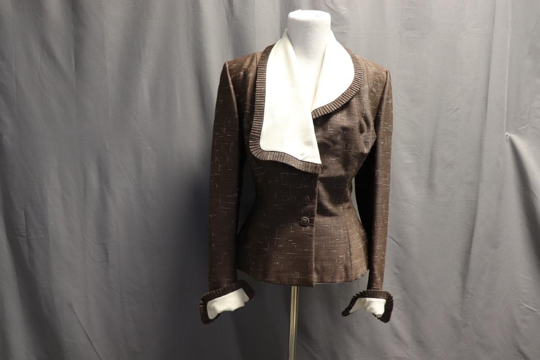 1940's Peplum by Lilli Ann of San Francisco: Brown with white dash like detail on linen silk blend. Pleated detail at cuffs, and collar is asymmetrical with pleated detail as well. Tag reads 'am original from Lilli Ann of San Francisco'. Covered