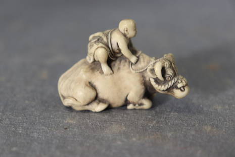 Vintage Netsuke Carved Bone Asian Buffalo Signed: Miniature netsuke carved bone Asian figure riding water buffalo. Approx. 2" long and 1 3/8" tall. Great condition.