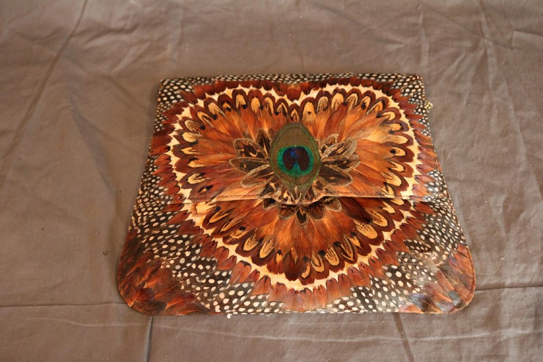 Vintage Peacock Feather Shoulder Bad: Peacock Feathers decoupaged on front and back. Great condition. Magnetic snap in front, velveteen lining with one inside pocket. Measures 9" long and 11" wide, chain is 35" long.