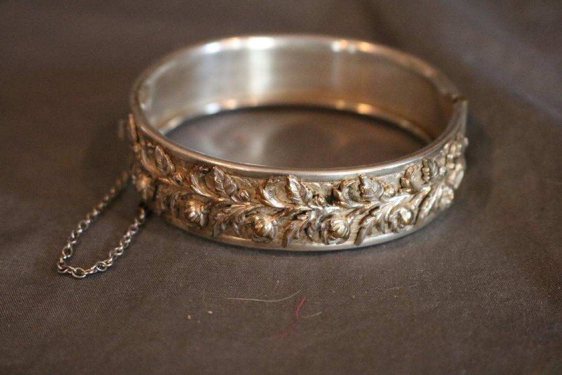 Vintage Carved & Raised Floral Bangle in Silver: nice bangle lots of detail has safety chain