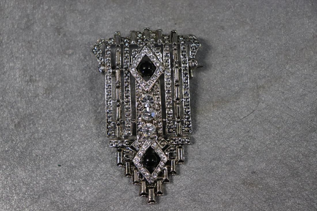 Vintage Silver-Tone Brooch, Rhinestones: Art Deco inspired brooch with rhinestones. Measures 2 1/4" long, 1 1/2" wide, great condition.