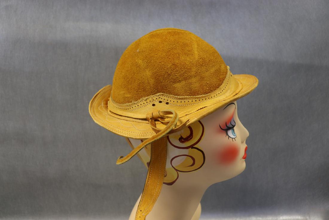 Vintage Suede Leather Gaucho Hat: Sturdy suede and leather bowl shaped, women's hat. Rawhide detail on top of hat, straps with buckle hold the hat in place. Stamped size 7, inside measurement 20 1/2" circumference. In great condition.