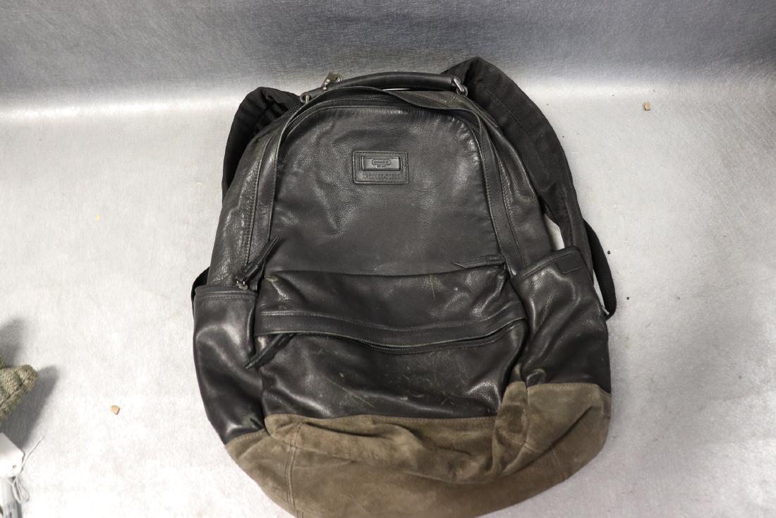 Vintage Coach Leather Back Pack: Numbered G116970533, black leather bag, brown suede bottom. Pockets outside and bag and inside as well. Measures approx. 16" tall, 11" wide and 6" deep. In good condition with some scratches on the bl