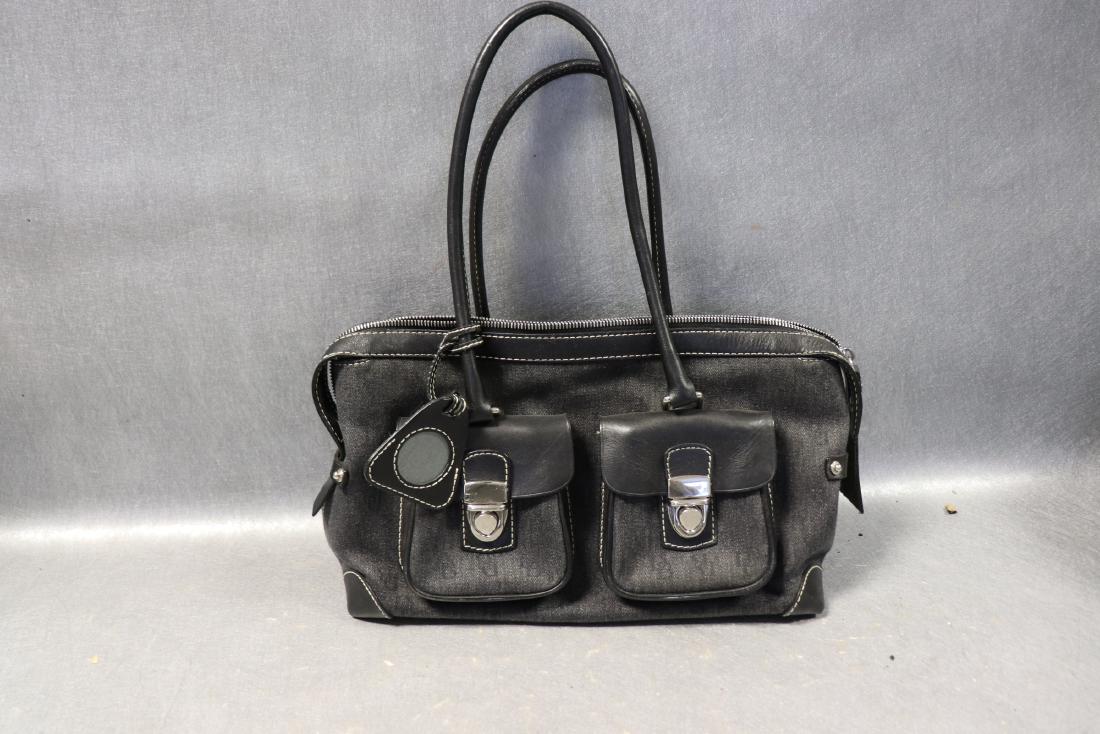 Dooney And Bourke Black Leather Hand Bag: Three outside pockets, two more inside. Constructed of black denim and leather. Approx. 13" wide, 8" tall, 4" deep. Great condition.