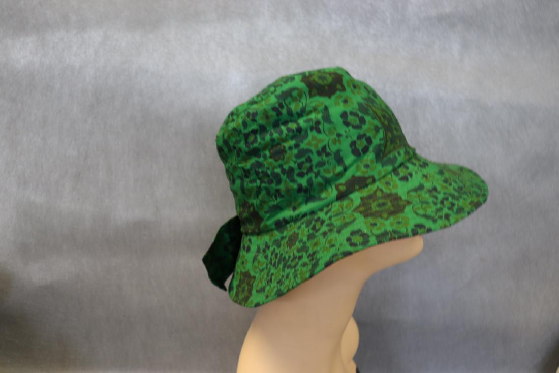Green Cotton Floral Hat: Bow detail on side, lined in black cotton, wide brim, approx. 23" around, inside, great condition.
