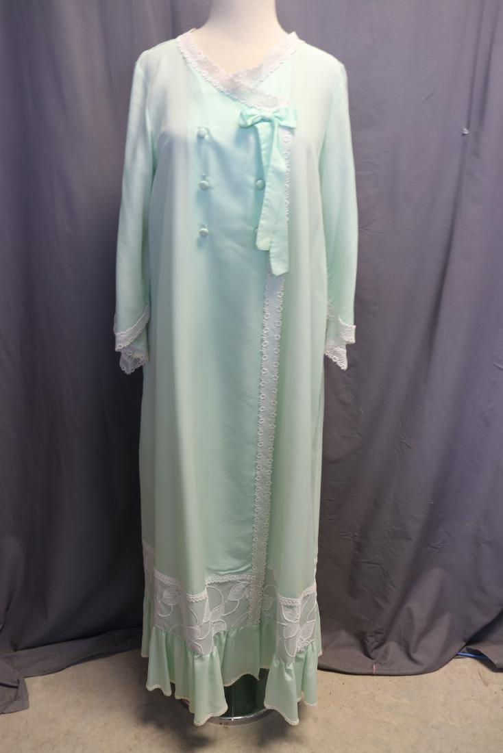 Vintage Christian Dior Mint Green Robe: Neiman Marcus tag sewn into side seam. 6 covered buttons and a snap in front, Schiffli lace around neckline and down the front, ruffle at hem with machine made lace. Measures approx. 38" bust, 42 at w