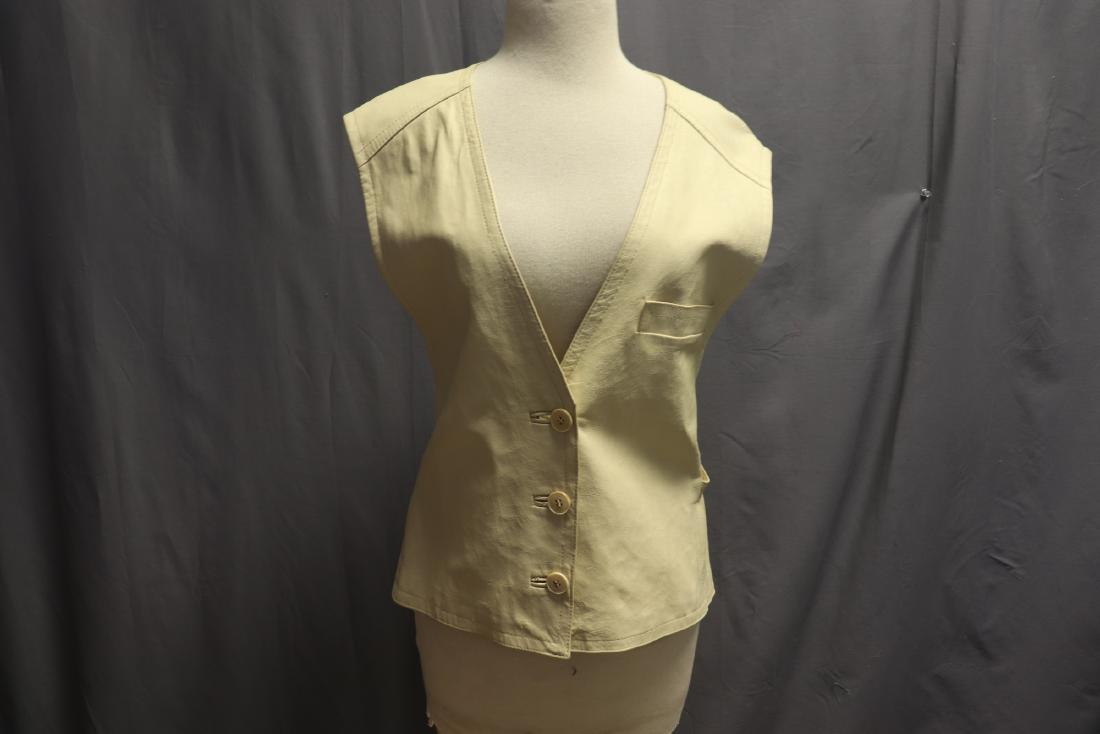 Vintage France Andrevie Leather and Knit Vest: Vintage women's blouse, tag reads "France Andrevie, Modele Depose, Paris", cream colored, front of vest is leather with buttons, back is a knit fabric with some stretch, vest is belted. In breast pock