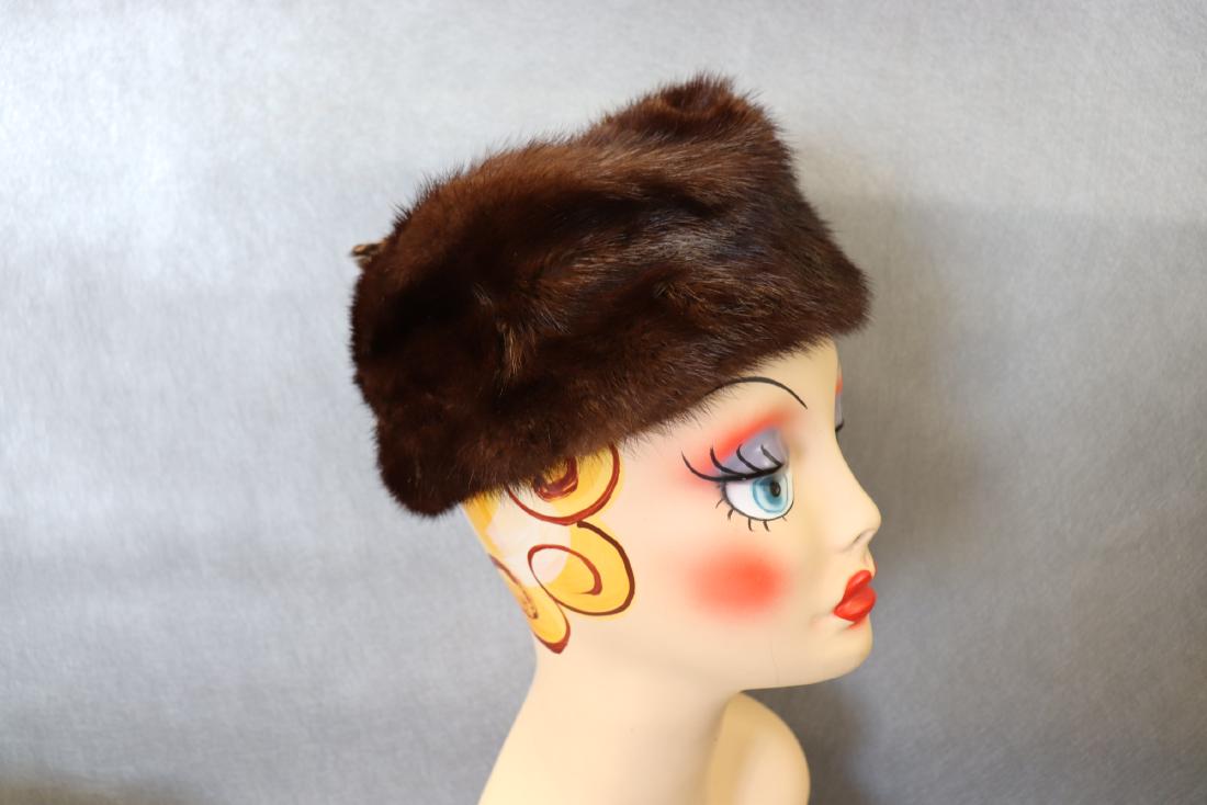 Vintage 1950's Mink Pillbox Style Hat: Features 2 mink paws sewn onto the seam, round fabric circle on top, Union Made label inside, measures approx. 20" around inside, 2 combs hold the hat in place. Great condition.