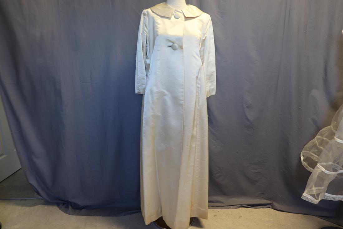 Vintage 1960's Cream Satin Maxi Evening Coat: Insulated lining, 2 large self covered buttons in front, 3/4 sleeves, peter pan collar. Measures 38" at bust, 42" at waist, and 56" long. Needs cleaning.