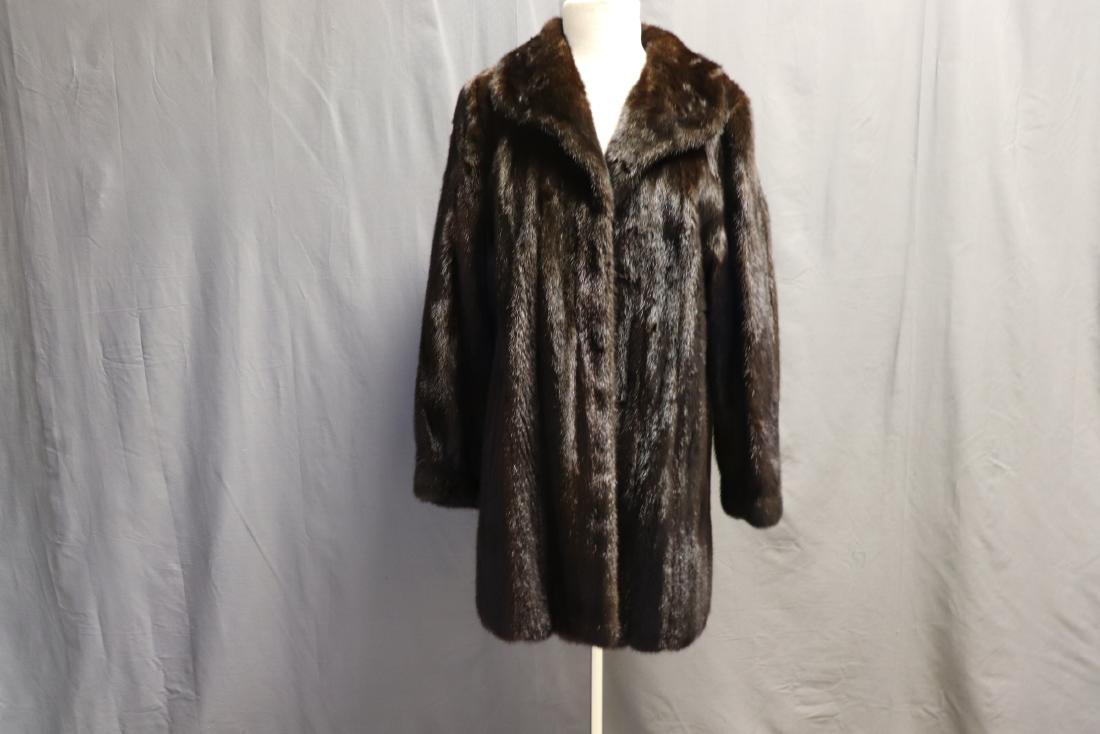 1960's Mink Car Coat: Three snap closures in front, one covered button on collar, long sleeves, slightly fitted at wrist, slightly rolled round collar, two side slit pockets, black lining, Name Florence embroidered into li