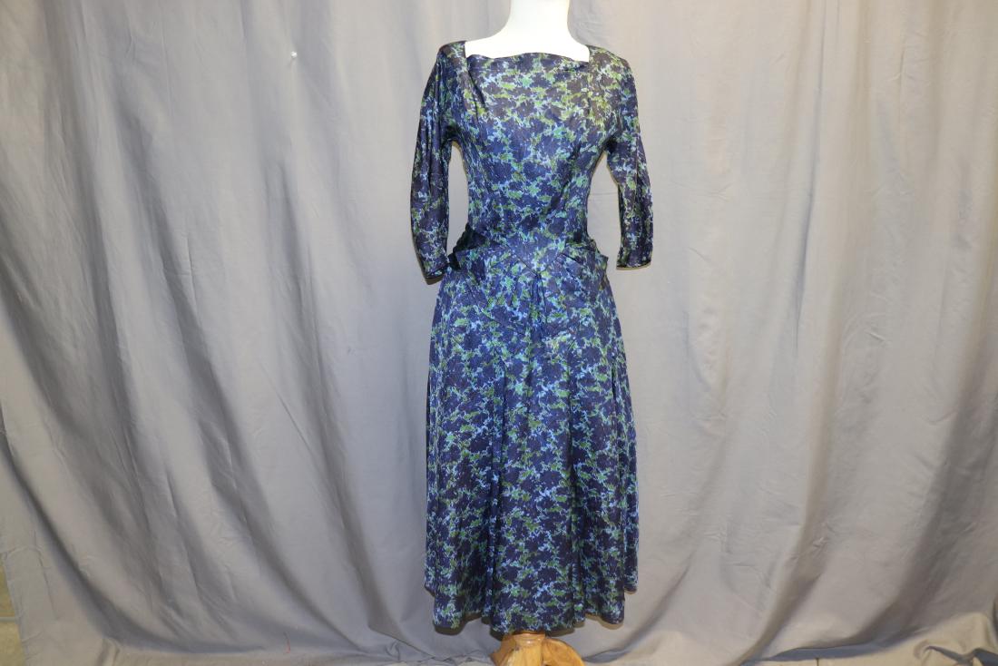 R&K Original 1950's Floral ilk Fit & Flare Dress: dolman 1/2 length sleeves, square neck line, fitted waist that comes to a point matching pleated fabric band and bow, full flared pleated circle skirt, beautiful blue and green fabric, back zipper, ni