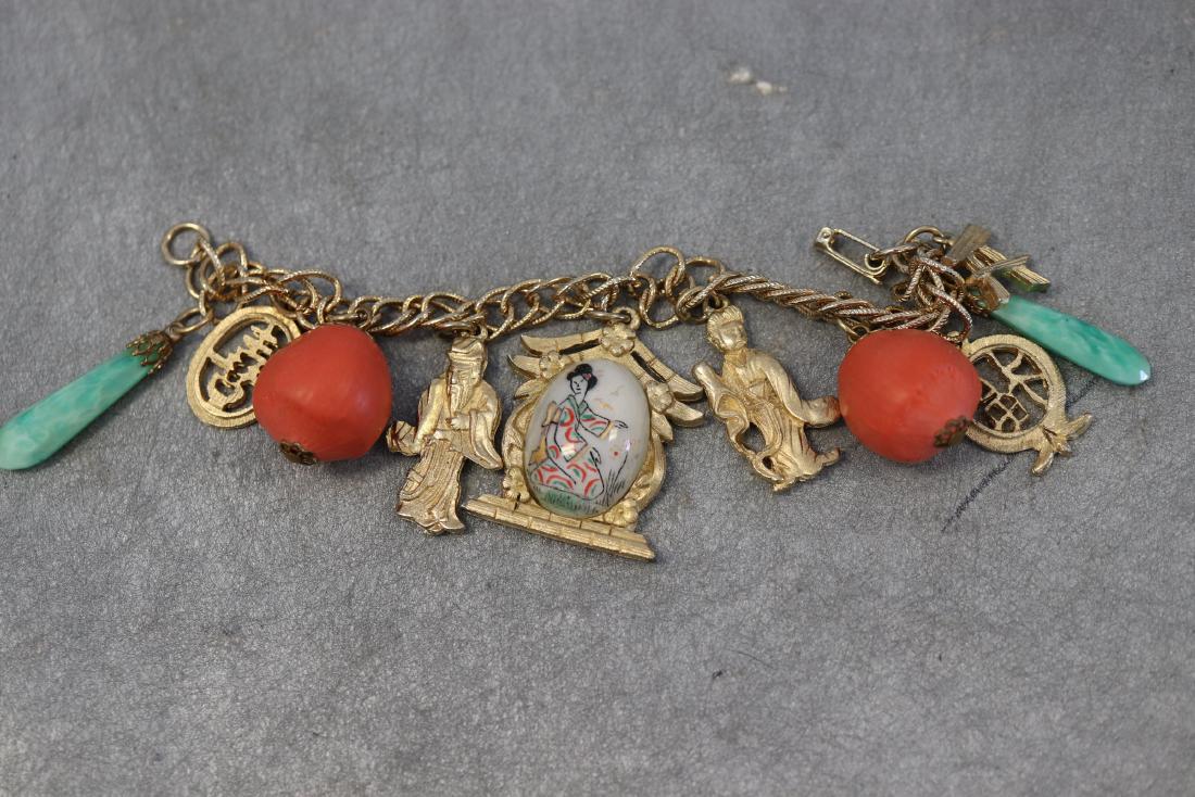 Vintage Gold Tone Asian Charm Bracelet: Features green jade and orange wooden beads, other Asian charms. In great condition.