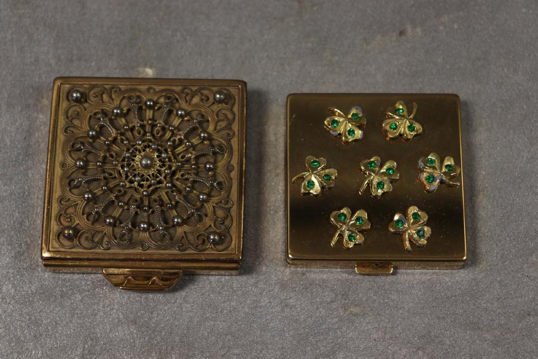 Lot of 2 Vintage 1940's Make-Up Compacts: Fancy filigree top with mirror inside, hidden compartment holds powder (still intact), 2 1/4 x 2 1/4", marked made in USA, some scratches on bottom, otherwise great condition. FLATO, 3-leaf clovers wi