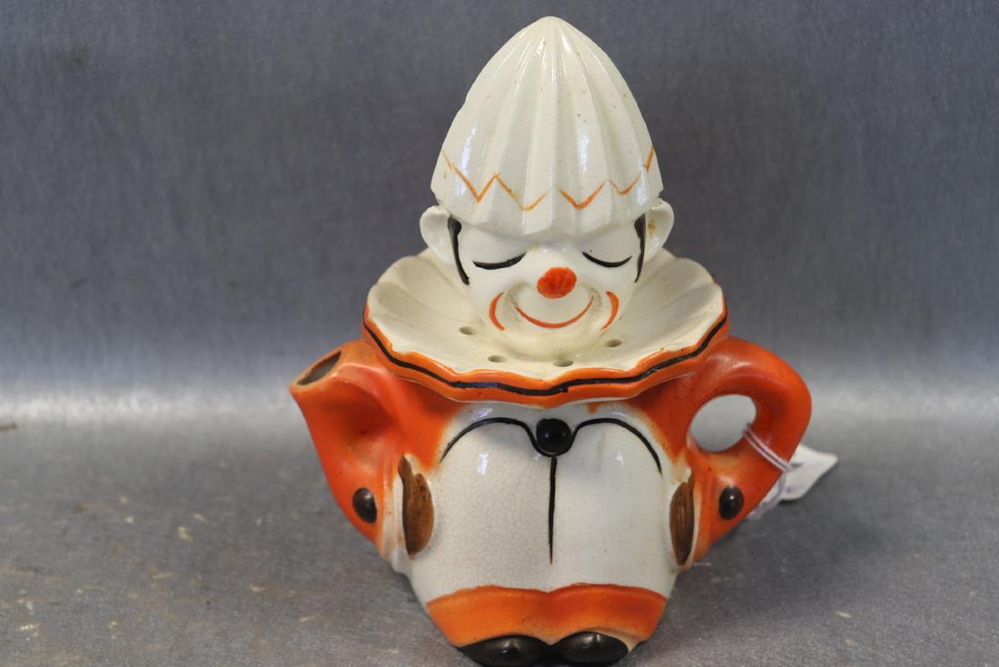 1930/40's Takito Clown Juice Reamer: Orange, black, white with juice catcher pitcher, made in Japan, pat # 45092. Measures 7" tall, 6 1/2" wide. Great condition with some crazing.