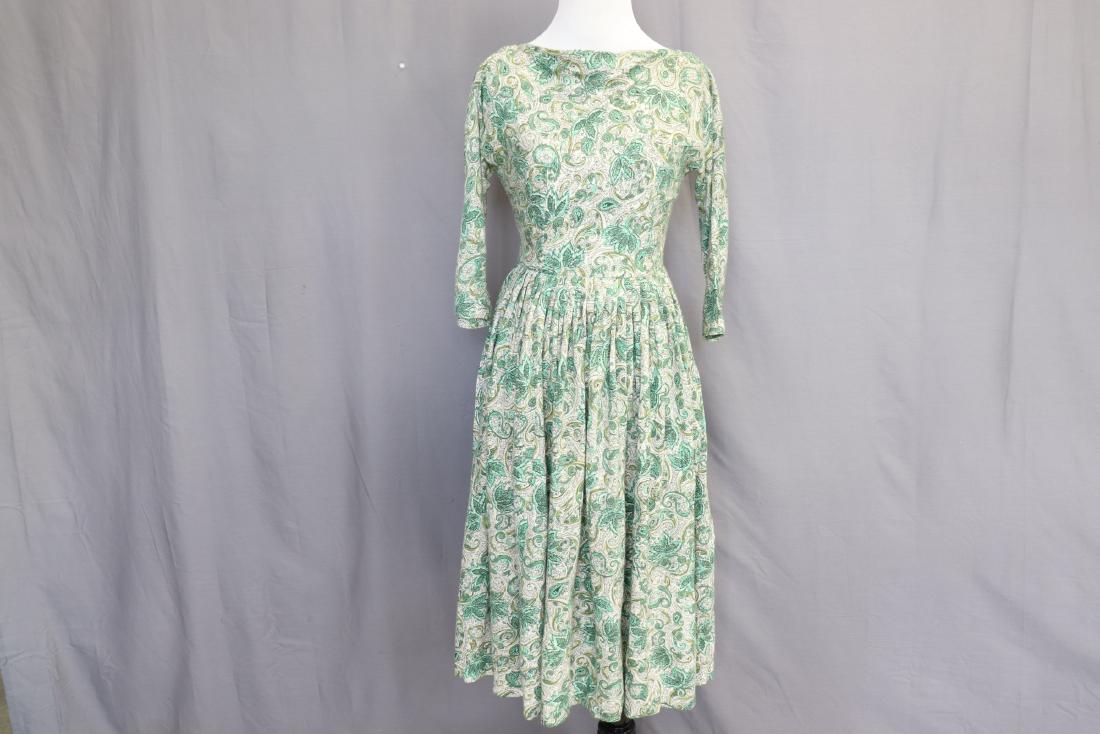 Wool Challis Green Bateau Neckline Dress: Bateau neckline, V-neck back, dolman sleeves, pleated waistline, metal zipper. Slightly discolored under arms, on lining and slight discoloration on skirt, otherwise good condition.