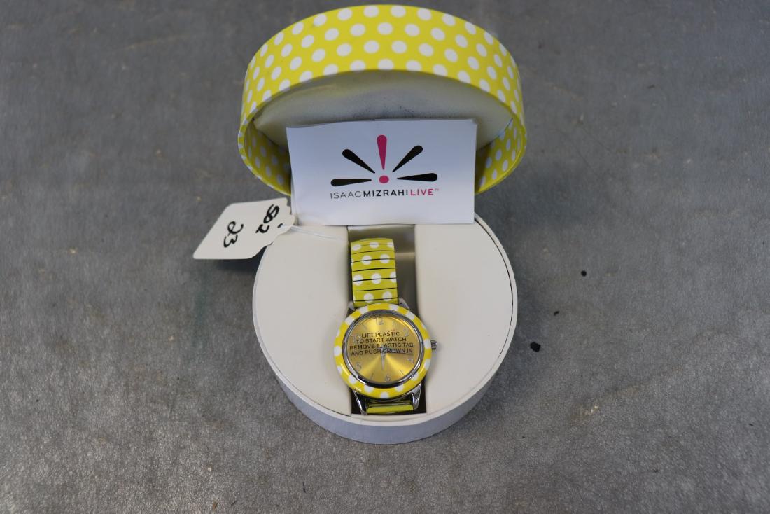 Yellow Polka Dot Isaac Mizrahi Wrist Watch: Yellow dotted time piece, stretch band, matching box. Silver tone trim, still has plastic protector film over face and backing. Great condition.