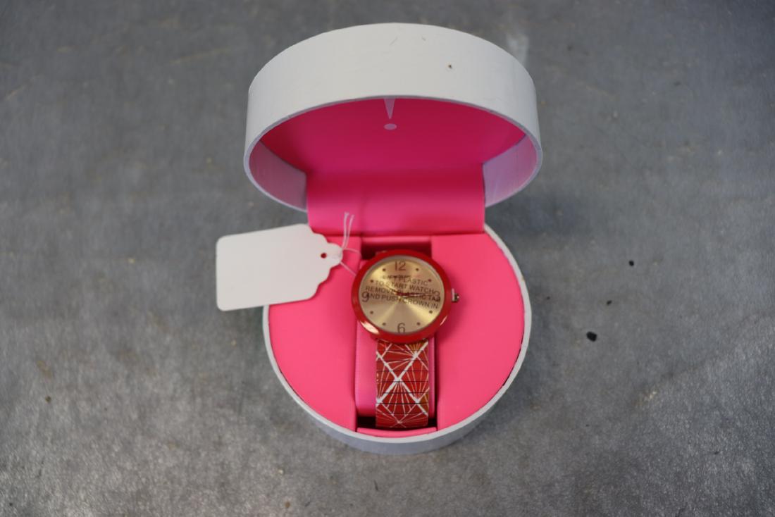 Red Geometric Print Isaac Mizrahi Wrist Watch: Red with geometric pattern time piece, stretch band, matching box. Still has plastic protector film over face and backing. Great condition.