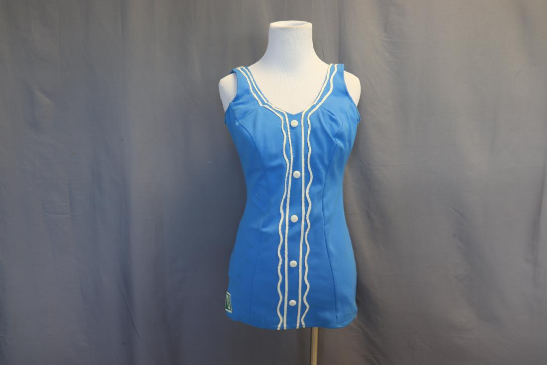 1950's Blue Knit Bathing Suit by Bryn Mawr: Believed to be a Bryn Mawr College suit. Covered buttons and applied braid on front, number 70 patch on side, labeled size 40, measures approx. 36 at bust, 28 waist, and 27 long. The padding in the br