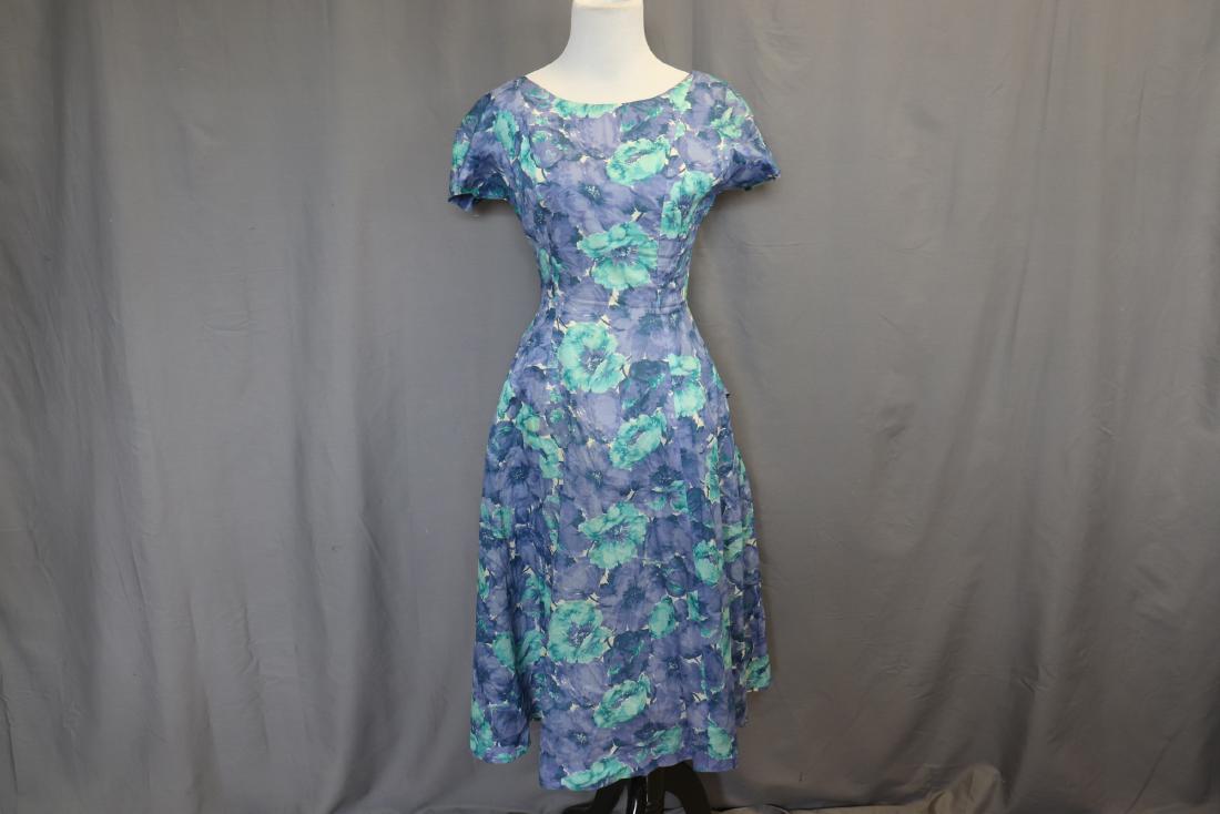 Vintage 1950's Cocktail Dress With Bow, Rhinestones: By Connie Chase for Bloomfield. Princess seaming, lined bodice, metal zipper in back, back bow with rhinestone detail attached. Net petticoat attached with safety pins inside. Measures approx. 32 bust