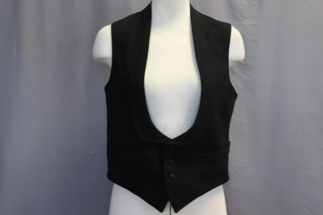 Antique 1910 Men's Black Wool Waistcoat, Paris: 4 front pockets, rounded lapels, fully lined, satin covered buttons, back buckle is stamped "Paris", measures approx. 34 chest, 14 across shoulders, 21 long. In nice condition.