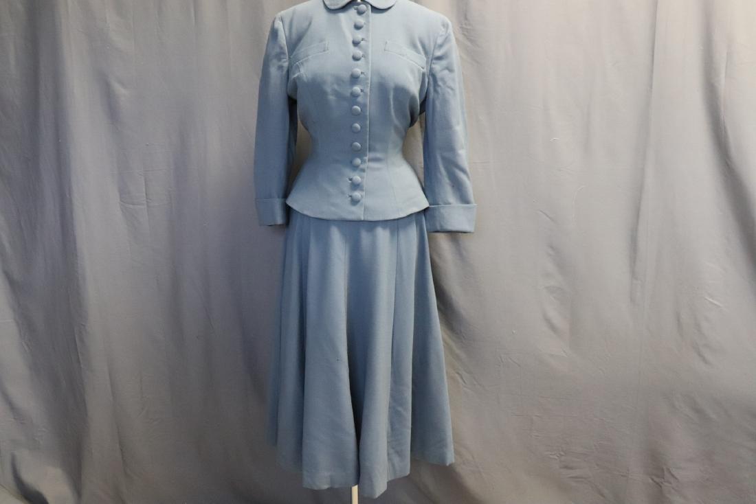 Vintage 1960's Blue Wool Suit by Forstmann: A very well made suit, for Fredleys, of Boston. Skirt has sewn-in netting interfacing plus rayon taffeta lining. It measures approx. 28 at waist, 31 long, some small holes in the wool. Jacket has cove